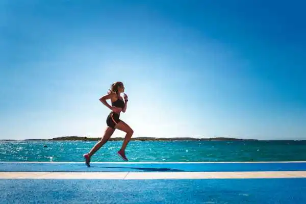 Woman running showing strong leg muscle Buckinghamshire
